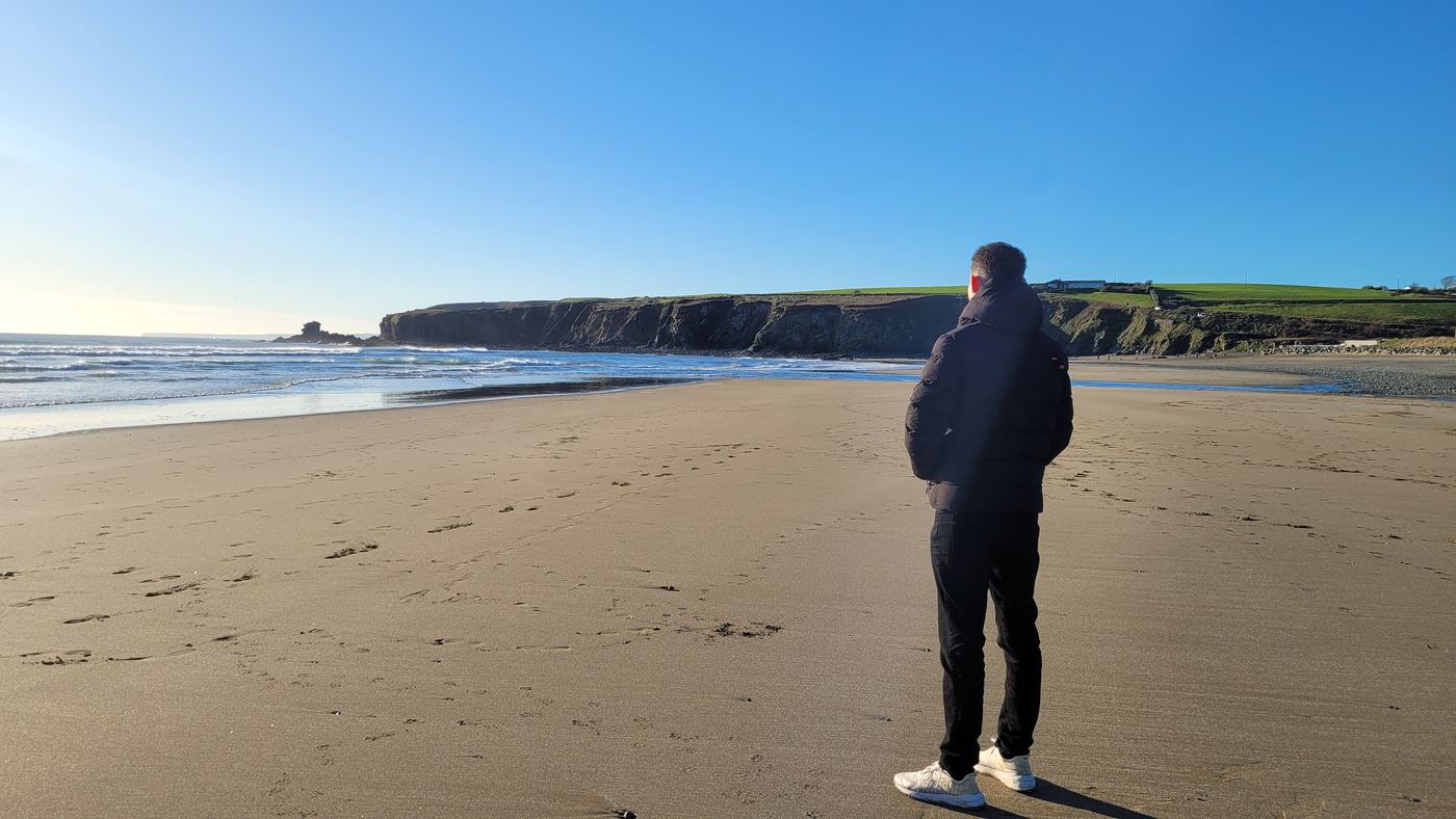 Elan Darcy looking out at the sea on an Irish beach on a sunny day